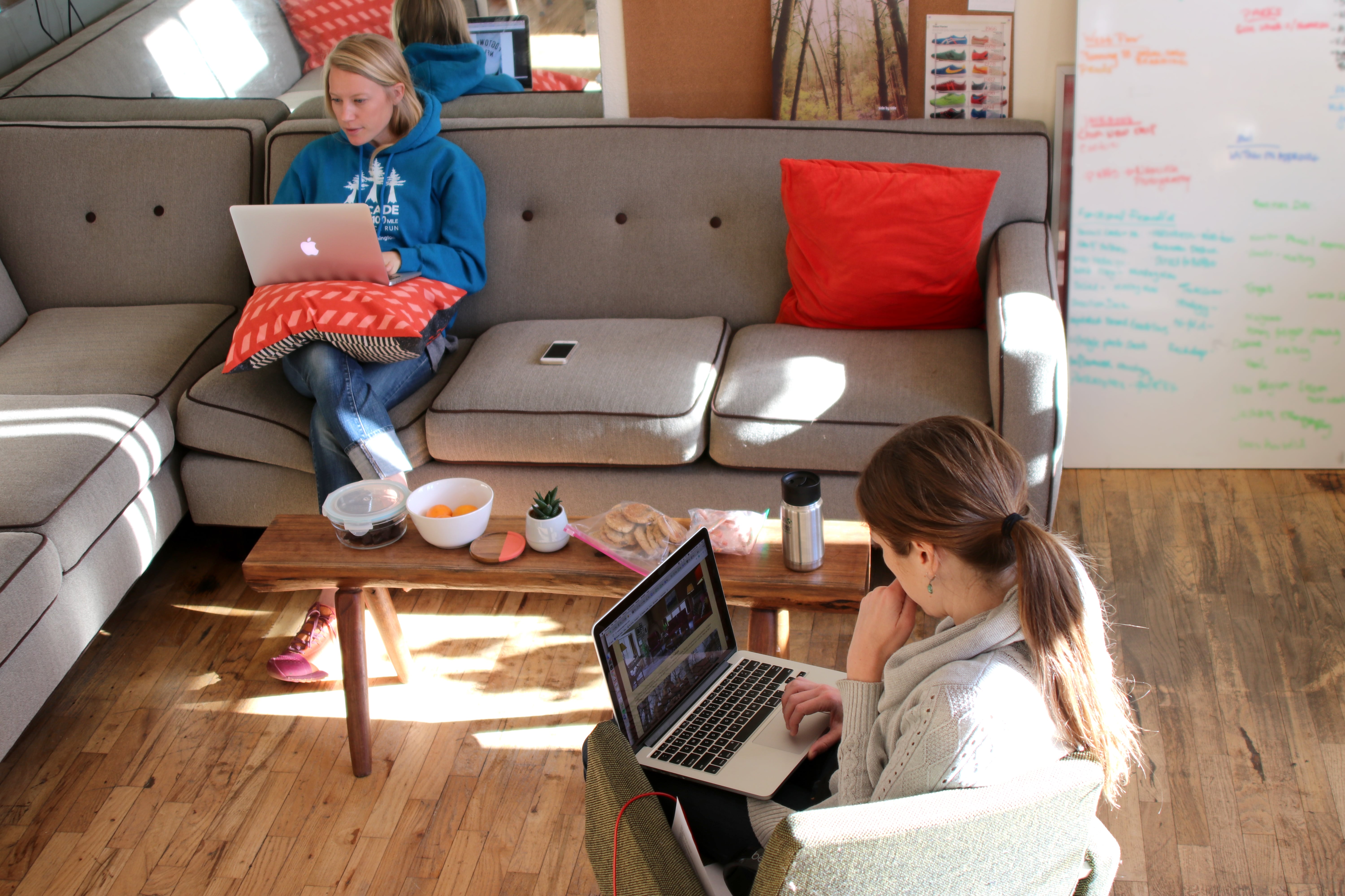 Walden Hyde employees working on their computers and sitting on the couch for contact page