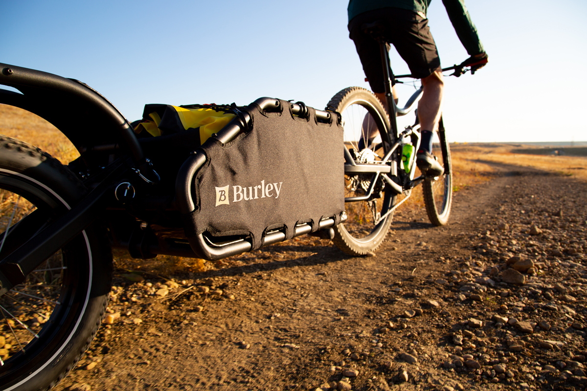 bike pulling Burley trailer with Burley brand identity