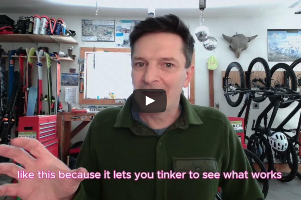 Robb in his workshop with pink words on screen about marginal gains allowing you to tinker