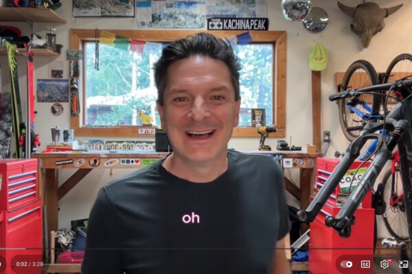 Robb in workshop with the words "oh" below in pink